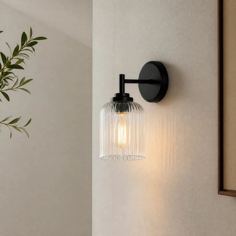 AOIOUR 10.4" 1‑Light Farmhouse Vanity Wall Sconce, Ribbed Glass Matte Black mounted on a wall with soft illumination.
