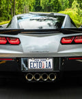Rear view of a sports car with a Cool Polka Dot Black And White License Plate Frame Two Pack Universal Fit Stainless Steel