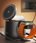 Top Shelf Qi2 Magnetic Wireless Charging Hub Featuring Rock Solid 15W Fast Juice Transfer And Genuine MFi Certified Apple Watch Stand For iPhone 17 Through 12 Series Plus AirPods With Straight Up Dependable 65W Power Brick Included on table, charging Apple Watch and AirPods.