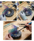 Hands using the Zero Stress Stained Glass Soldering Station, aligning glass pieces at precise angles for soldering.