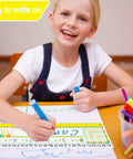 Child writing on paper with Multiplication Desk Reference Name Plates For Students Kid Friendly Self Adhesive Manuscript Tags