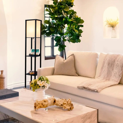 Maxwell Shelf Floor Lamp With USB Ports, Wireless Charging Pad, And Built In Outlet in a modern living room with white sofa