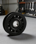 Durable Idler Pulley Replacement for Walk Behind Mowers, Fits Most Brands, Easy Install, plastic construction on workshop table