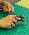 Person using Vane And Wrap Stripping Tool Pro Grade For Arrows With A Sharp Long Lasting Blade Safe Angled Cut Via Preformed Channel