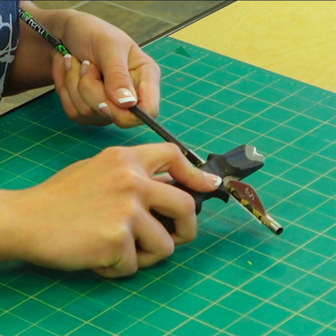 Person using Vane And Wrap Stripping Tool Pro Grade For Arrows With A Sharp Long Lasting Blade Safe Angled Cut Via Preformed Channel