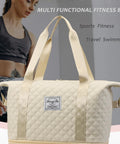 Rolling duffle bag, front view: white quilted fabric with twin carrying handles and front brand patch.