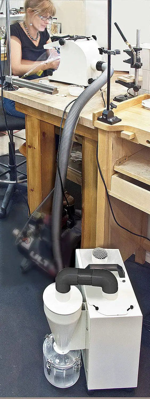 Heavy Duty Cyclone Dust Collector With High Efficiency HEPA Filtration And Remote Switch Box in a workshop with a vacuum hose.