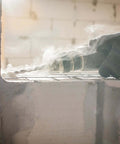 Side view of 1/2 in x 18 in SDS-Plus carbide-tipped masonry drill bit in use on a concrete block.
