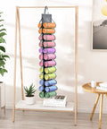 Tshirt And Leggings Closet Organizer With 24 Compartments Space Saving Hanging Storage For T Shirts Jeans Scarves And Activewear Easy Foldable Gray Organizer Pack Of 3 hanging with colorful rolls inside, displayed on wooden stand in living room.