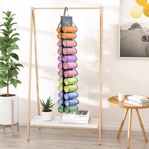 Tshirt And Leggings Closet Organizer With 24 Compartments Space Saving Hanging Storage For T Shirts Jeans Scarves And Activewear Easy Foldable Gray Organizer Pack Of 3 hanging with colorful rolls inside, displayed on wooden stand in living room.