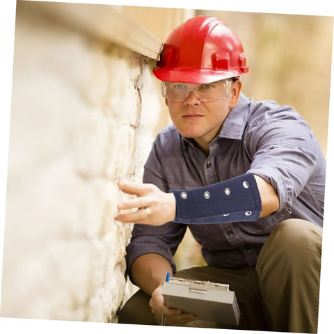 Slip On These Hella Tough Cut Resistant Arm Sleeves For Reliable Lightweight Wrist Guard Protection Built For Mechanic Jobs Welding And Outdoor Projects, worn by a worker inspecting a wall.
