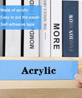 Person inserting paper into Clear 8 Inch Acrylic Name Plate Holder 2x8 Inch Wall Sign Display on wooden surface