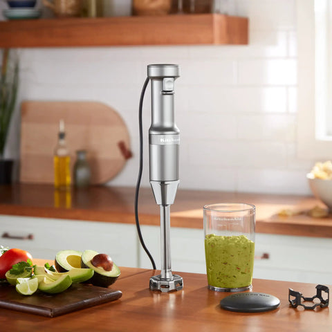 Hassle Free Variable Speed Corded Hand Blender With Razor Sharp Stainless Steel Blades For Smoothies Soups And Hummus on a kitchen counter.