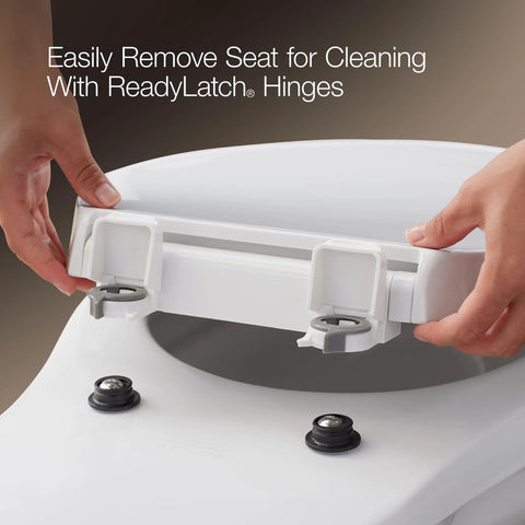 White KOHLER Cachet elongated toilet seat with ReadyLatch hinges being installed on a toilet.