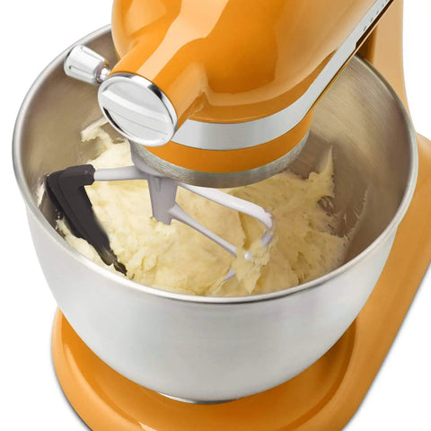 Orange mixer with Flex Edge Beater Replacement for KitchenAid Tilt-Head Stand Mixers, 4.5-5 Quart, mixing dough in a metal bowl.