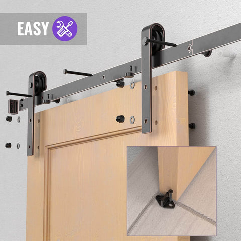 Orb Oil Rubbed Bronze Sliding Barn Door Hardware Kit With 6.6 Foot Track Rails installed on wooden door, showing J shape rollers.