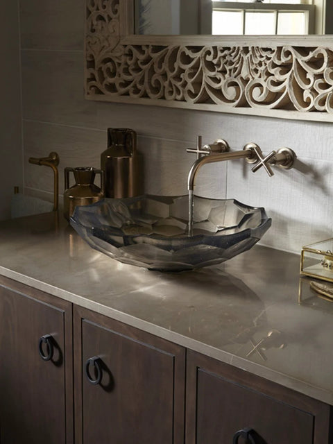Modern bathroom vanity with Kohler Jacquard Ring Pull in black finish installed on cabinet drawers, featuring ornate mirror and metal faucet