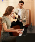 Woman playing 88 Key Weighted Hammer Action Digital Piano With MIDI In Out 200 Sounds And Rhythms, man with guitar beside her