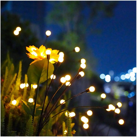 Solar Firefly Pathway Lights 6 Pack Warm White LED Garden Decor Waterproof Outdoor Solar Powered Lights With Wind Sway And 8 Flicker Modes For Yard And Patio Pathway Vibe glowing in a garden at night.
