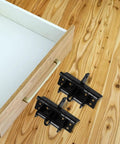 Two Pack Spring Door Hinges Self Closing With Adjustable Tension 90 Degree Rotation Zinc Alloy Invisible Hinges next to open drawer.