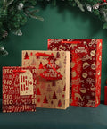 Festive gift bags with holiday designs next to pine branches, no visible 12 Piece Set Of Large Kraft White Gift Bags With Red Paper Accents.