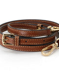 Hella Sturdy Adjustable Cowhide Leather Shoulder Strap Kit With Vintage Gold Hardware Game Changer For Mini Purse Easy Punch Free Installation Brown And Gold Crossbody Converter, showing a close-up of the brown leather strap with gold clasps.
