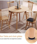 Heavy Duty Chair Leg Floor Protectors And Furniture Sliders With Bumper Glides For Hardwood Surfaces That Deliver A Slick Smooth Glide And Top Tier Scratch Defense While Keeping Your Floors Fresh In A Solid 20 Piece Set on wooden table and chairs.