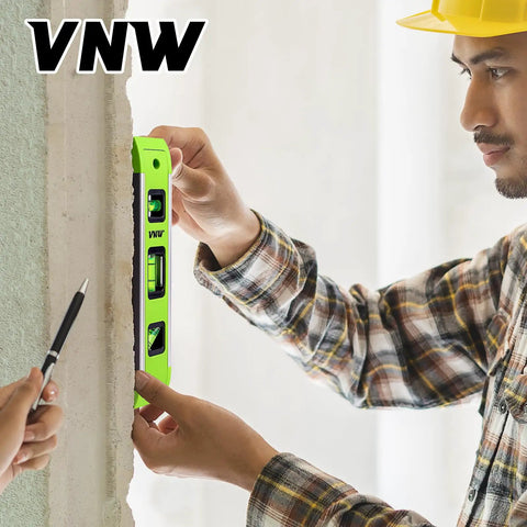 Heavy Duty Nine Inch Torpedo Level With Mighty Magnet Strip and Triple Clear Vials used for precise wall alignment.