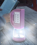 Three In One LED Lantern For Camping And Emergencies Ultra Compact And Lightweight Light on picnic table with person reading