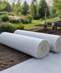 Heavy Duty Polyester Ground Cover Mat With Built Like A Tank Weed Barrier and Water Permeable Drainage Design for outdoor landscaping, rolled up.