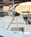 Installed adjustable marine-grade aluminum rear bimini top support pole on white boat; cockpit gauges visible.