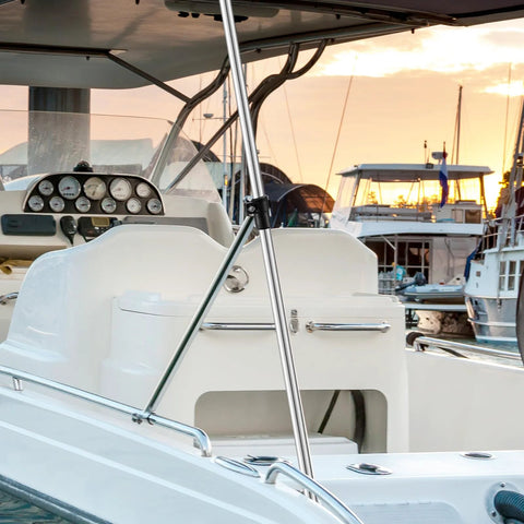 Installed adjustable marine-grade aluminum rear bimini top support pole on white boat; cockpit gauges visible.