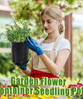 Woman holding black plastic plant nursery pot in garden setting