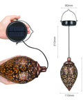 Close-up of 2 Pack Hanging Solar Lights With Moroccan Olive Pattern Lanterns, showing solar panel and detailed metal lantern design.