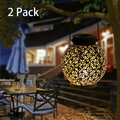 Outdoor Solar Lanterns Hanging Lights For Patio Porch Backyard Decorative Garden Lamps Metal Waterproof LED Lanterns With Auto On Off No Fuss Easy Setup Create Charming Shadow Patterns Two Pack illuminating a garden seating area at night.