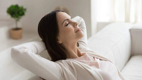 Woman relaxing on sofa in a bright room