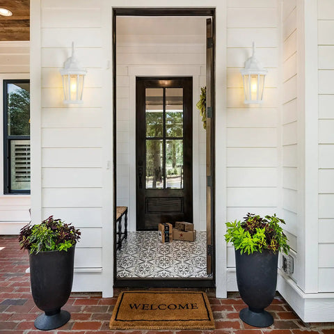 Large Outdoor Wall Lantern Light Fixture for porch and exterior shown on white house with clear glass panels and matte black finish