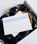 White Self Seal Confidentiality Envelopes 115mm By 225mm For Office Documents And Shipping displayed on floral fabric