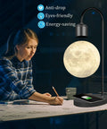Levitating Lamp With Wireless Phone Charger, Floating Light Bulb Table Light illuminating a desk, Magnetic Levitation Night Light