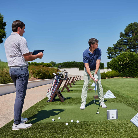 Man using Launch Monitor And Golf Simulator Bundle With Dual Doppler Radar And 100K Courses for outdoor practice feedback