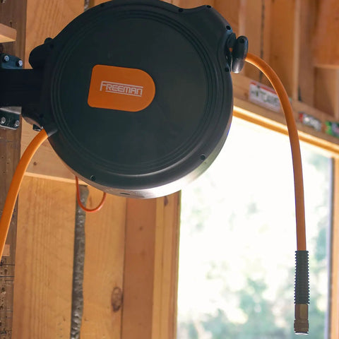 Compact Retractable Air Hose Reel With Brass Fittings And Mounting Bracket One Quarter Inch By Sixty Five Feet in garage