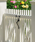 Stainless Steel Gate Hook and Eye Latch Screws for Door Window Shed Barn on a white picket gate with flowers in background.