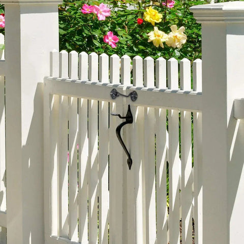 Stainless Steel Gate Hook and Eye Latch Screws for Door Window Shed Barn on a white picket gate with flowers in background.