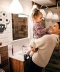 Bathroom with woman holding child, displaying a Sheep Toilet Paper Holder Stand And Wall Mount Shelf For Bathroom Storage Space Saver Farmhouse Decor Holds Up To 7 Rolls 8 Optional Freestanding Or Wall Mounted Organizer Rack.