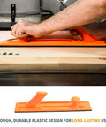Heavy Hitter Table Saw Push Block And Push Stick Kit Featuring Stackable Feather Board For Rock Solid Kickback Control and Dead Smooth Cuts On Router Tables and Jointers with hands using orange block on wood.