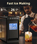 Portable Ice Maker With Self Cleaning Function 8 Cubes In 6 Minutes 26 Lbs Per Day Countertop Ice Machine For Home Kitchen RV Travel On The Go Matte Black on kitchen counter with bartender pouring drink.