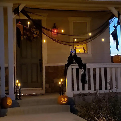 Porch decorated with 24 Pack Flameless Taper Candles With LED Flicker, 6.5 Inch Warm Yellow Dripless Candlesticks for Halloween Decor