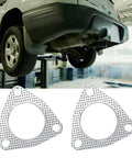 Two graphite 2.5-inch exhaust flange gaskets with a 3-bolt pattern for manifold/muffler, shown beside a lifted car.