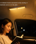 Pack Of Three Motion Activated Rv Step Lights With 10 Bright Leds And Instant Trigger Easy Peasy Install Cordless Battery Powered Magnetic Night Light Strip For Camper Trailer Motorhome Solid Warm Glow illuminating a woman reading in a car at night.