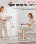 Two women using Mobile Standing Desk On Wheels, Sit Stand Laptop Table With Lockable Casters, Adjustable 7 Level Height, White